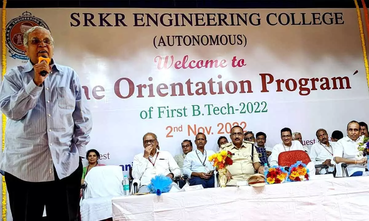 Retired IAS officer D Chakrapani addressing first year students of SRKR Engineering College at a programme in Bhimavaram on Wednesday