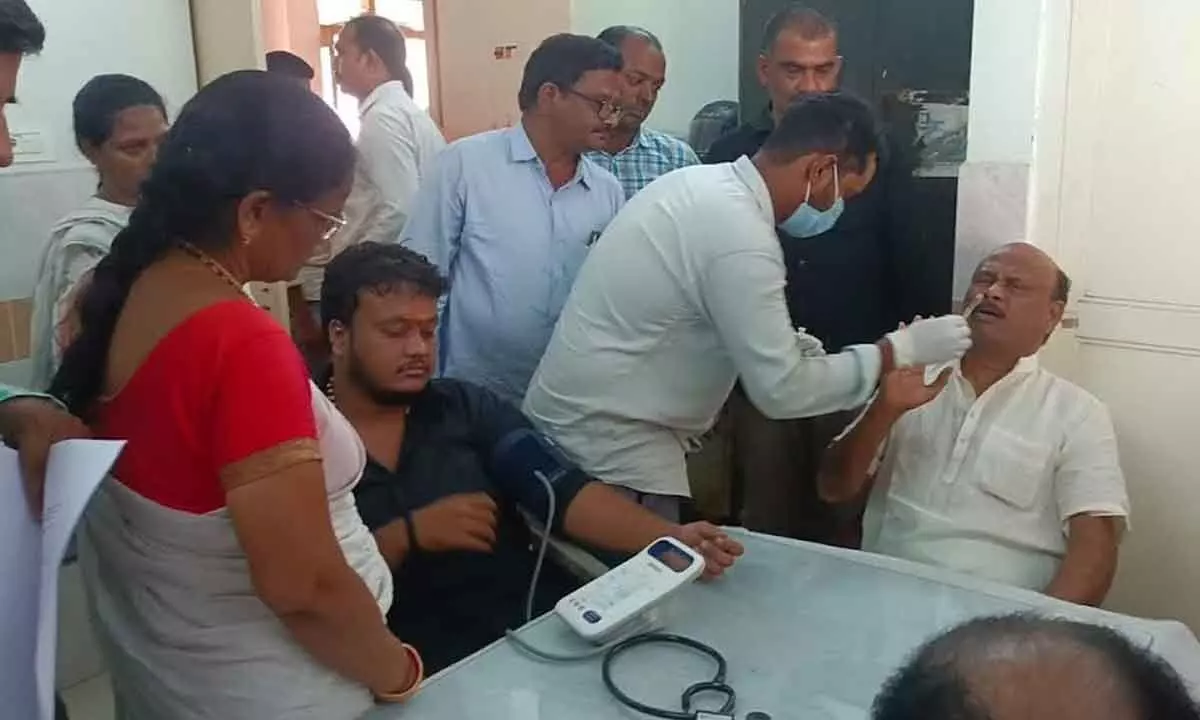 Former minister Ch Ayyanna Patrudu and his son undergoing medical examination in Visakhapatnam on Thursday