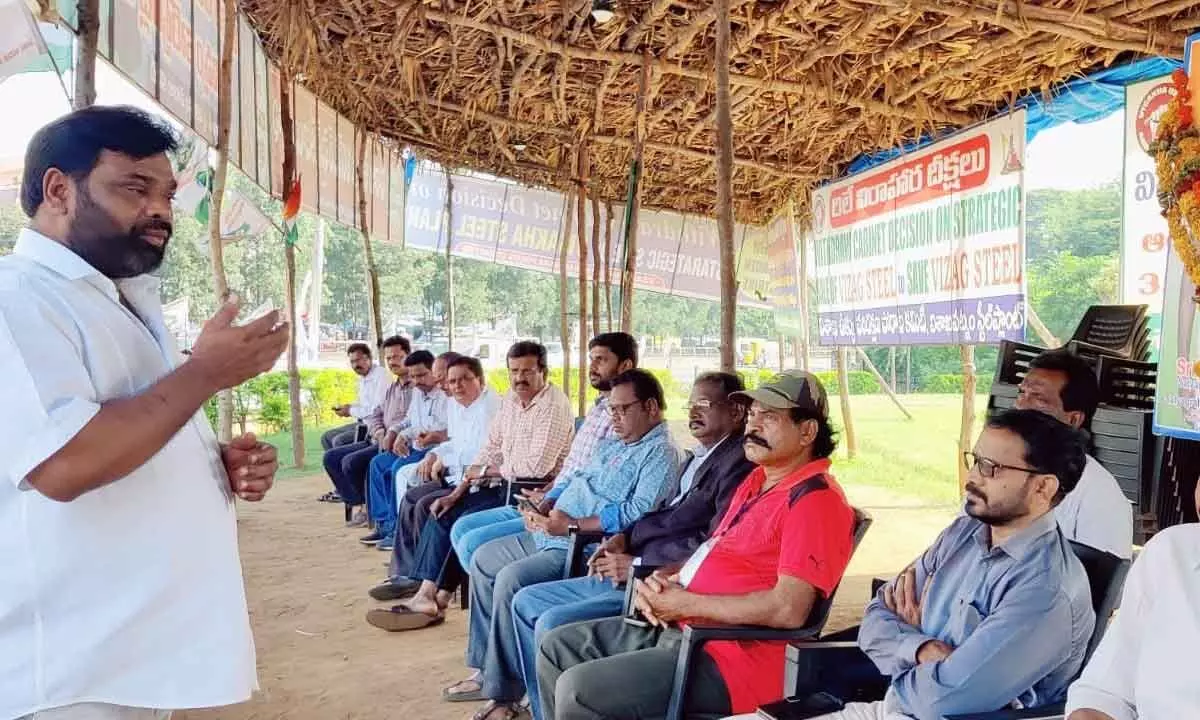 Trade union leader V Srinivasa Rao addressing the agitators at the relay hunger strike camp in Visakhapatnam on Thursday
