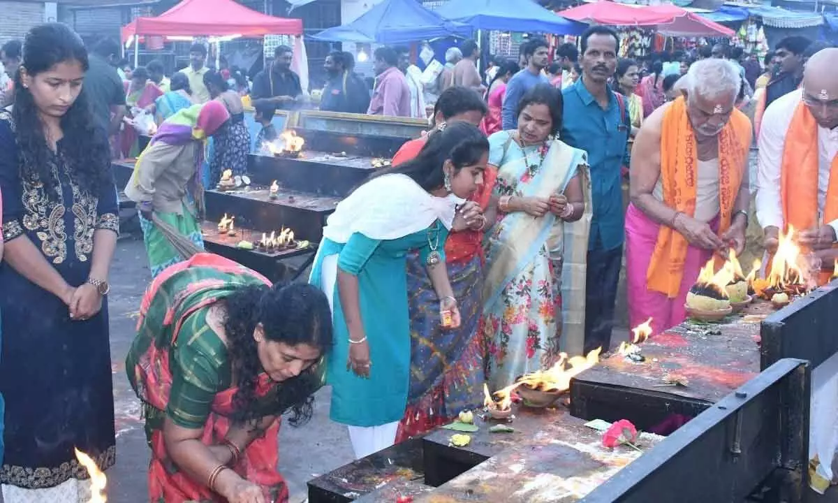 Devotees lighting the lamps in temple