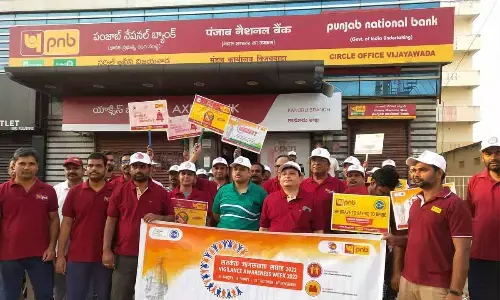PNB Vijayawada circle office staff taking out a walkathon in Vijayawada on Sunday