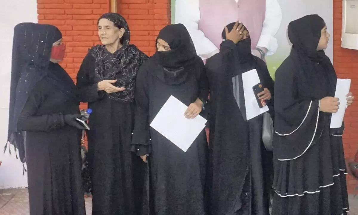 Muslim women wait outside Delhi BJP office for MCD election tickets in New Delhi on Monday