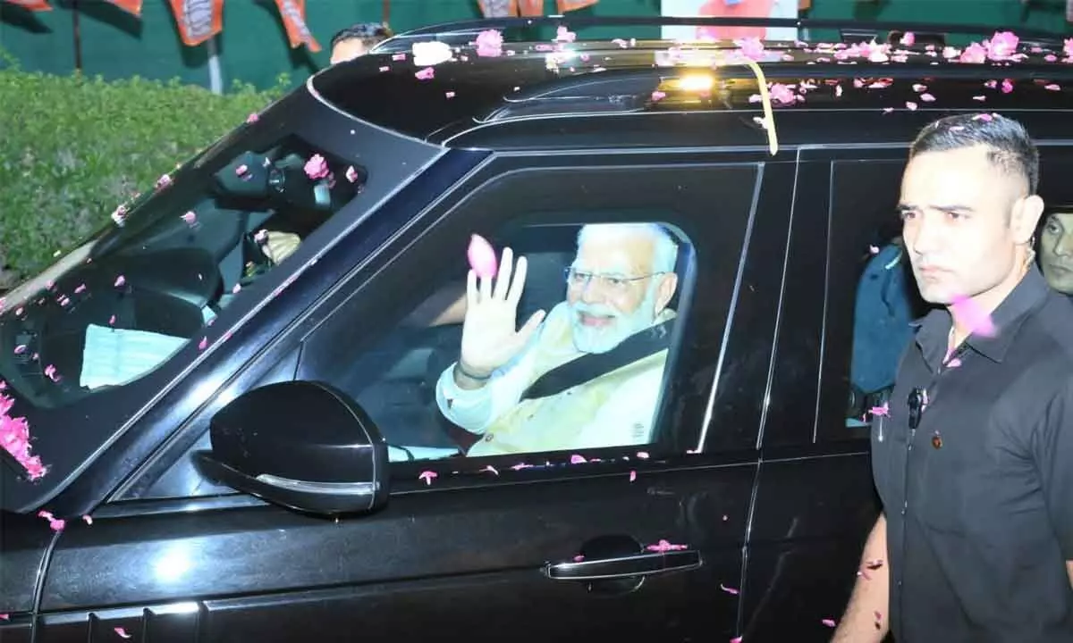 Prime Minister Narendra Modi taking part in a road show in Visakhapatnam on Friday