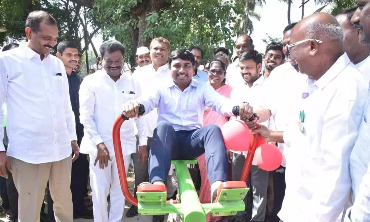 Palnadu District Collector Siva Sankar Lotheti working out in the gym after inaugurating it at a park in Narasaraopet on Wednesday. MLA Dr Gopireddy Srinivasa Reddy is also seen.