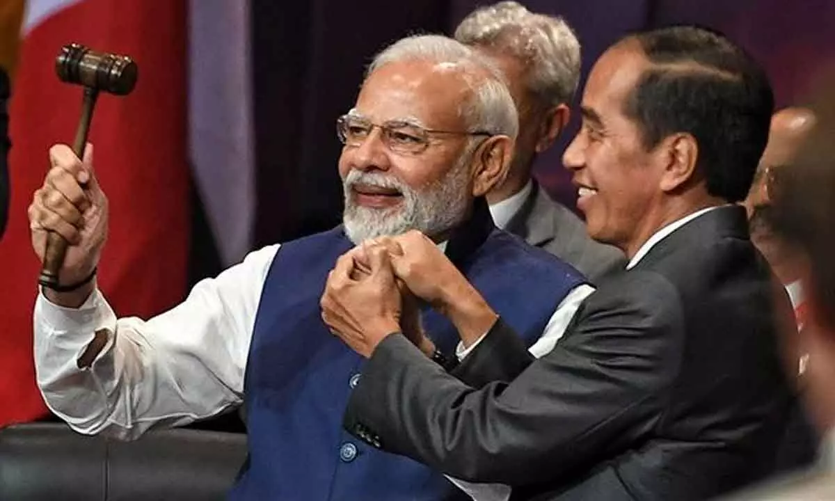 President of Indonesia Joko Widodo symbolically hands over the G20 Presidency to Prime Minister Narendra Modi at G20 summit, in Bali, Indonesia on Wednesday