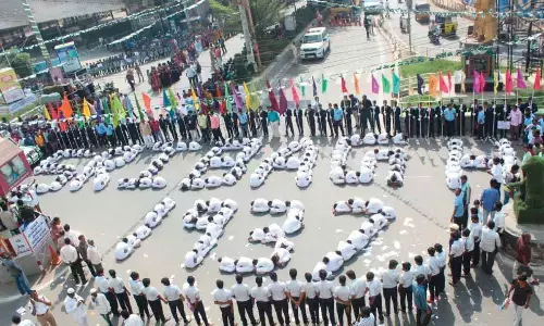 Advocates, students of various schools and colleges and the leaders of student organisations taking part in a human chain in Kurnool on Wednesday