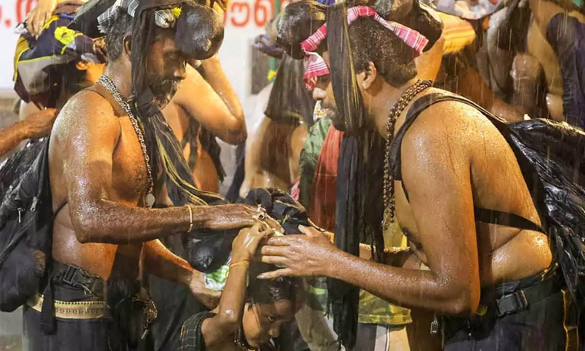 Lord Ayyappa devotees arrive at the Sabarimala temple amid heavy rains as the annual Mandalam-Makaravilakku pilgrimage begins