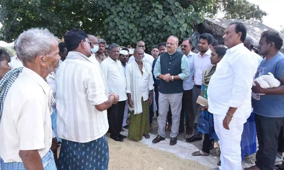 Civil supplies commissioner B Arun Kumar interacts with farmers at Punadipadu village of Kankipadu mandal Krishna district on Thursday