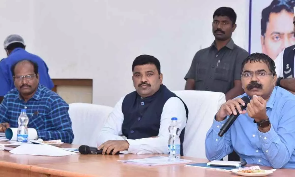 Krishna District Electoral Roll observer MV Seshagiri Babu speaking at a meeting at the Collectorate in Machilipatnam on Friday. Krishna District Collector P Ranjith Basha is also seen.