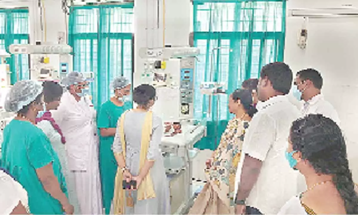 Tirupati TDP  in-charge M Sugunamma looking at the newborn baby at the Maternity Hospital on Monday
