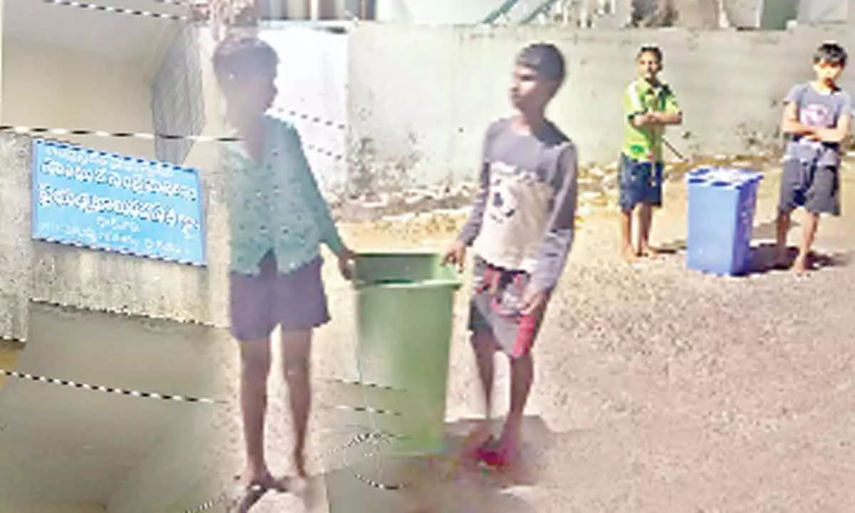 SC Hostel at Mallayya Agraharam, Kakinada; Students carrying garbage bins in the hostel during nights