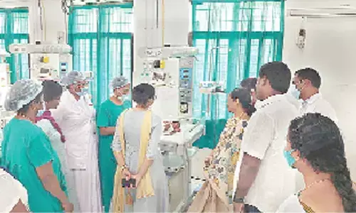 Tirupati TDP  in-charge M Sugunamma looking at the newborn baby at the Maternity Hospital on Monday