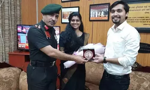Brigadier Lalit Sharma presenting a memento to Rahul and Karthika