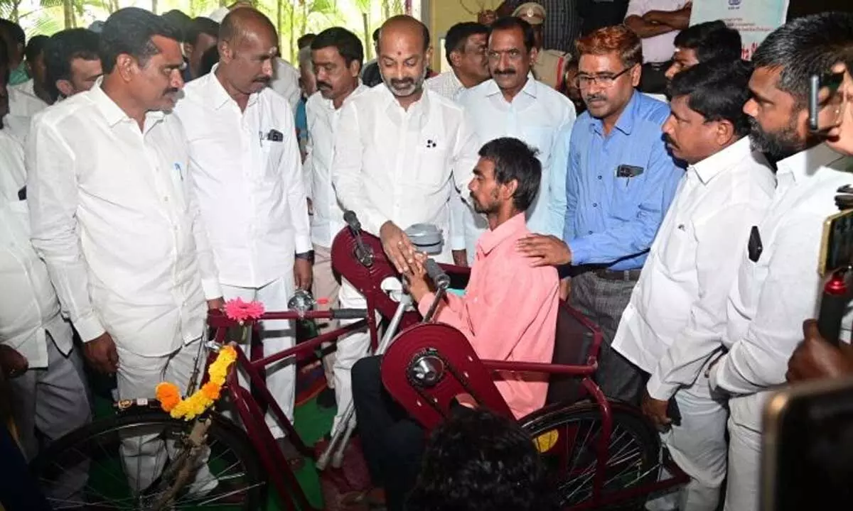 MP Bandi Sanjay Kumar distributing special equipment for the convenience of disabled at Vemulawada in Sircilla district on Thursday