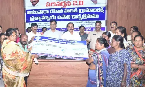 Agriculture Minister Kakani Govardhan Reddy handing over financial support to Kapparallatippa villagers in Nellore on Friday