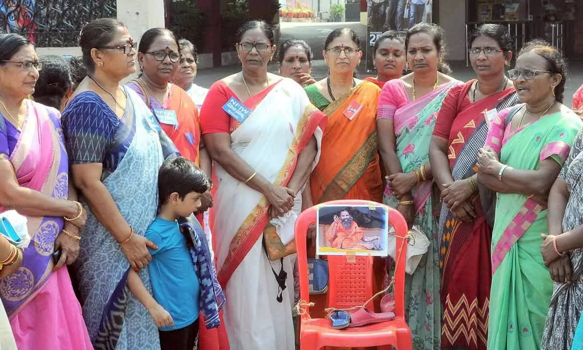 AP women wing leaders and activists staging a protest against the comments of Ramdev Baba,  at Urvasi Centre in Vijayawada on Sunday