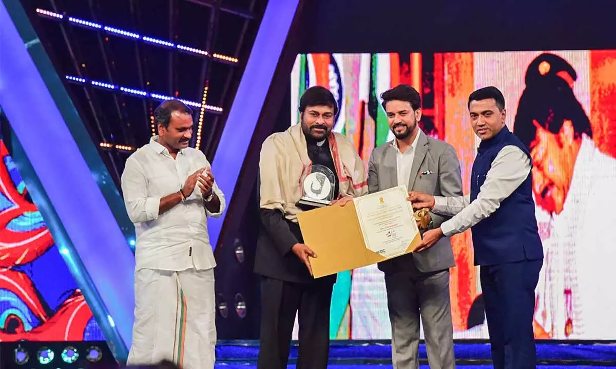 Actor Chiranjeevi being conferred with Indian Film Personality of the Year Award by Union minister Anurag Thakur and Goa CM Pramod Sawant during the closing ceremony of IFFI in Goa on Monday