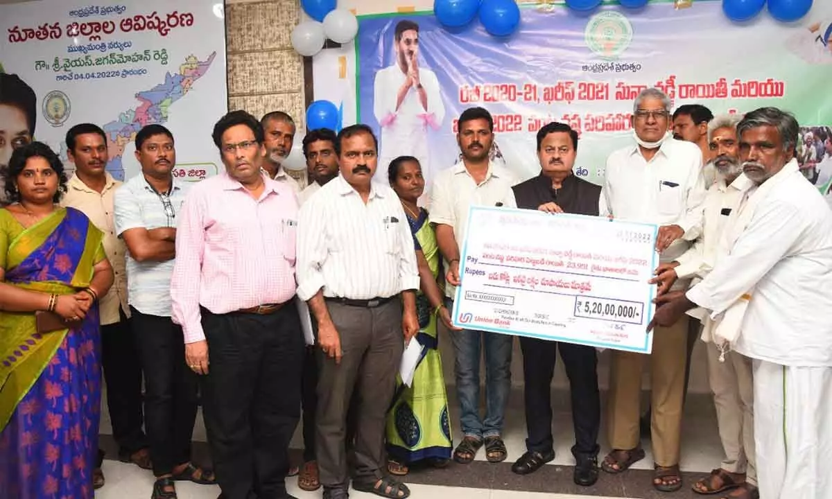 District Collector K Venkataramana Reddy, Agriculture Advisory Board Chairman Raghunath Reddy and others releasing replica of cheque Rs 5.20 crore towards farmers welfare in Tirupati on Monday