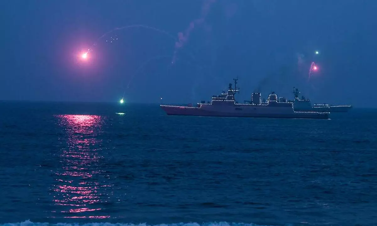 As a part of the naval operational demonstration rehearsal, the Indian Navy ship being lit up at the coast of Visakhapatnam.