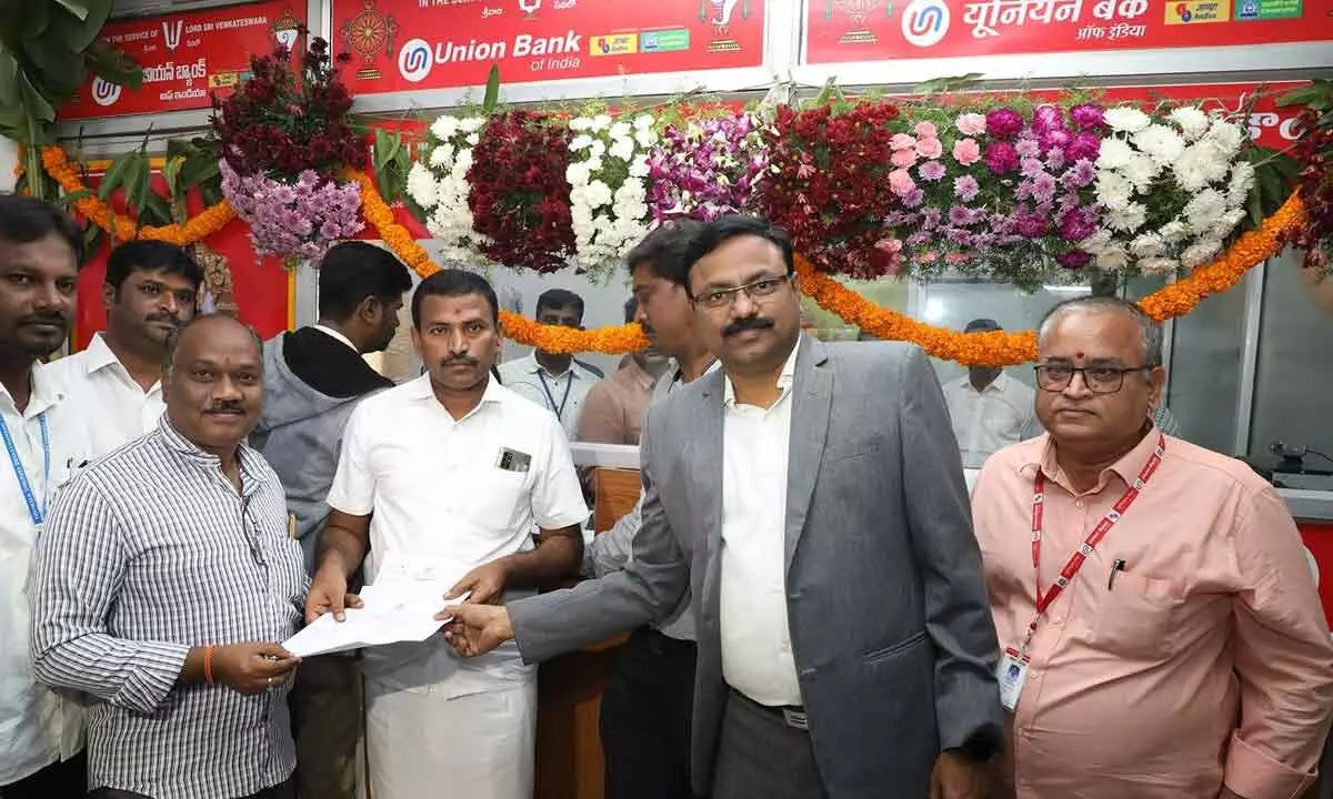 TTD JEO Veerabrahmam issuing the first Srivani ticket to N Lakshmi Harish and  G Roop Sindhu couple of Guntur, after inauguration of Srivani offline darshan counter, in Tirupati on Wednesday