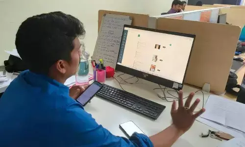 A cop checking the data of the mobile App connected to the hotel in Anakapalli district