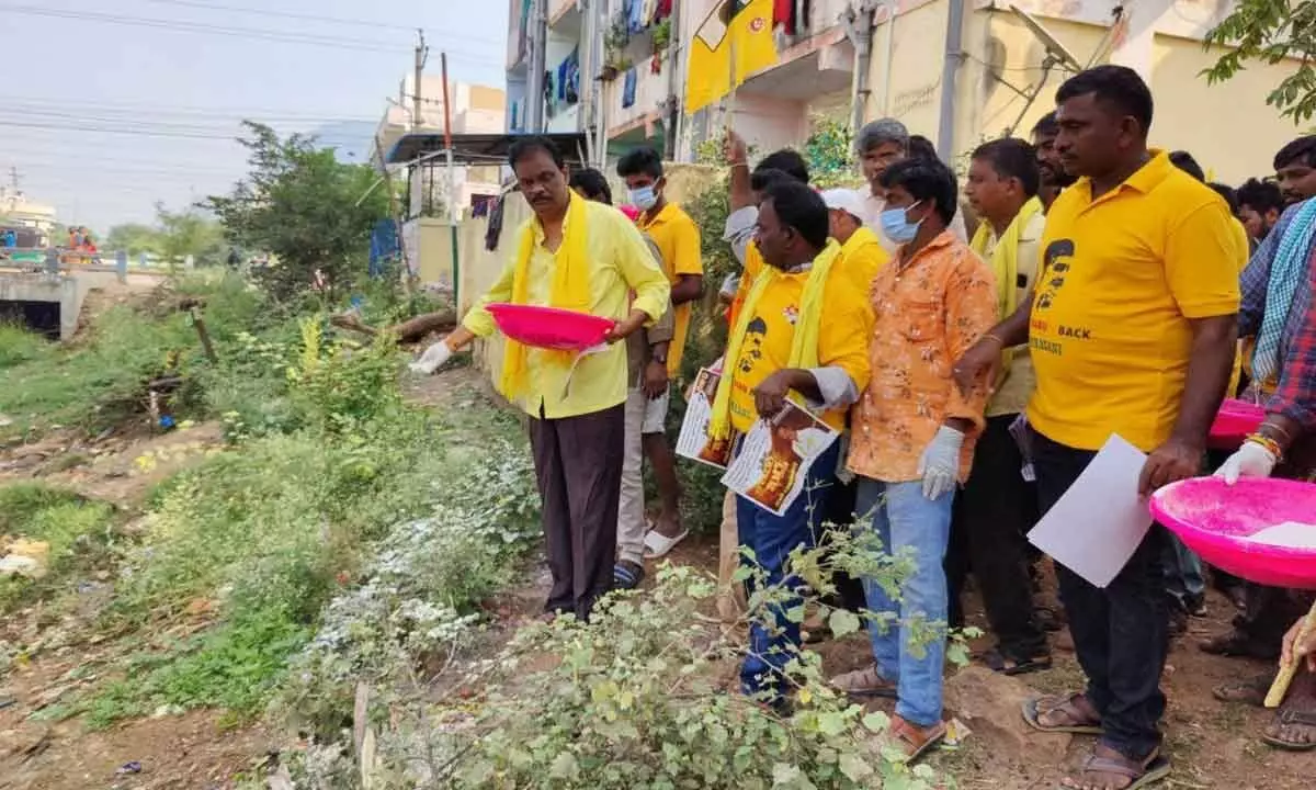 TDP district vice-president Bommasani Subba Rao and others doing sanitation works in Jakkampudi Colony on Thursday