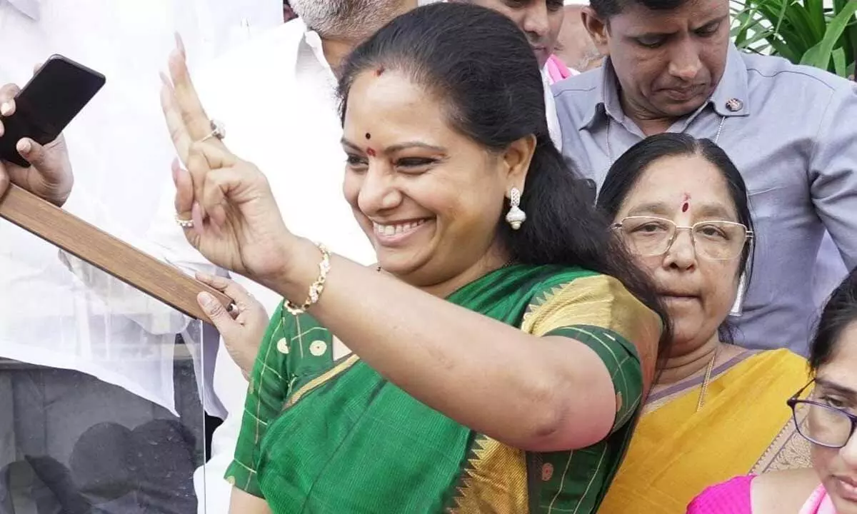 TRS MLC Kavitha waves to supporters at her residence in Hyderabad on Thursday Photo: Adula Krishna