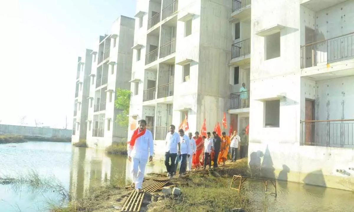 CPI State secretary K Ramakrishna inspecting TIDCO houses in Ongole on Friday