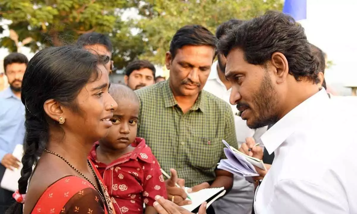Chief Minister  Y S Jagan Mohan Reddy assuring the woman to extend financial support for her 4-year-old boy at  Parna Palle village of Lingala mandal on Friday