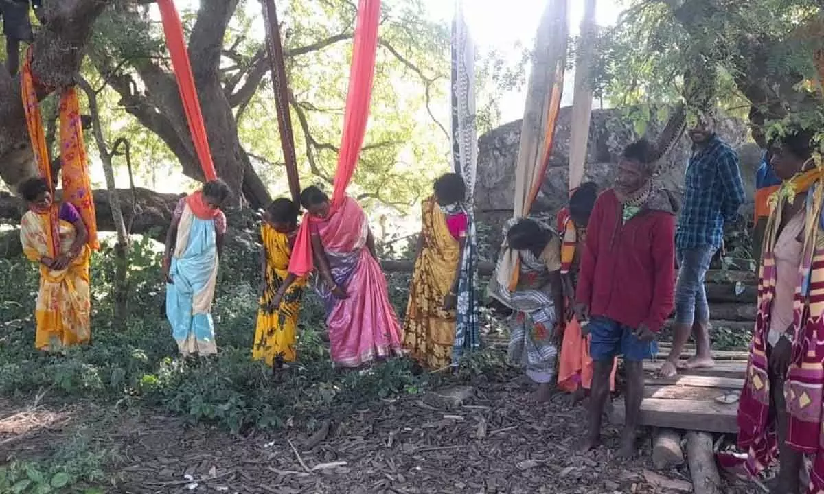 Tribal women staging a mock hanging protest in Booriga village on Friday