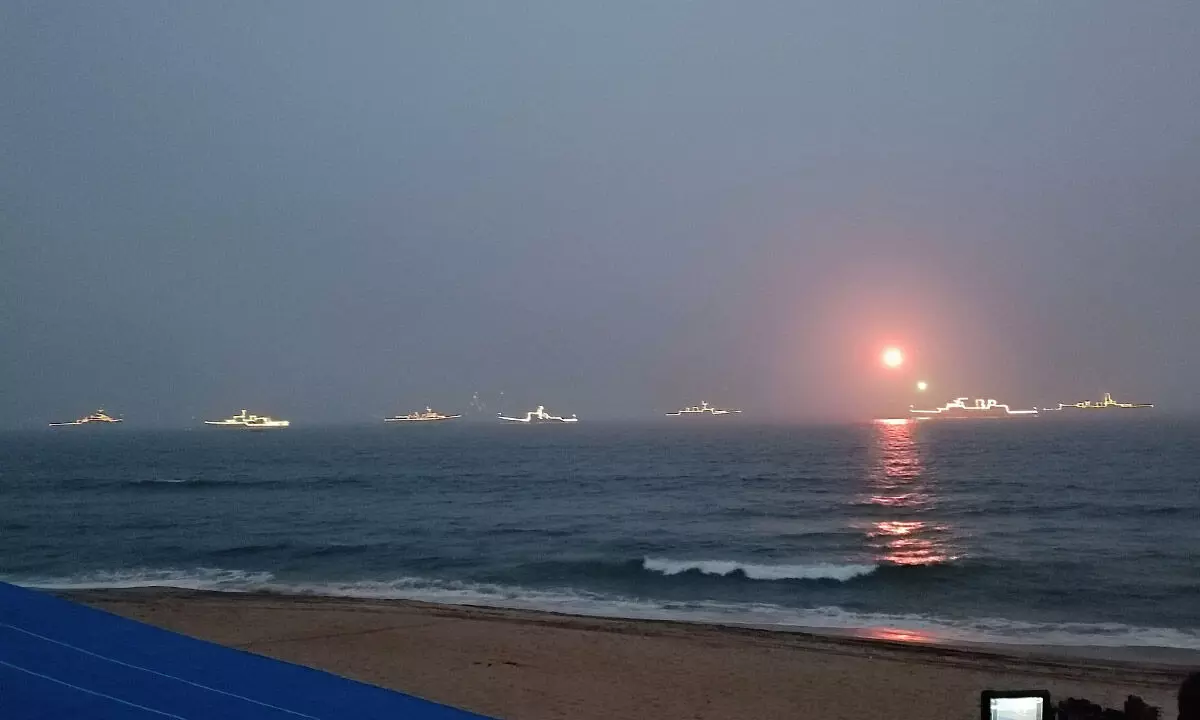 Ceremonial sunset and illumination by ships at sea as a part of Navy Day celebrations held in Visakhapatnam on Sunday. Photos: Vasu Potnuru