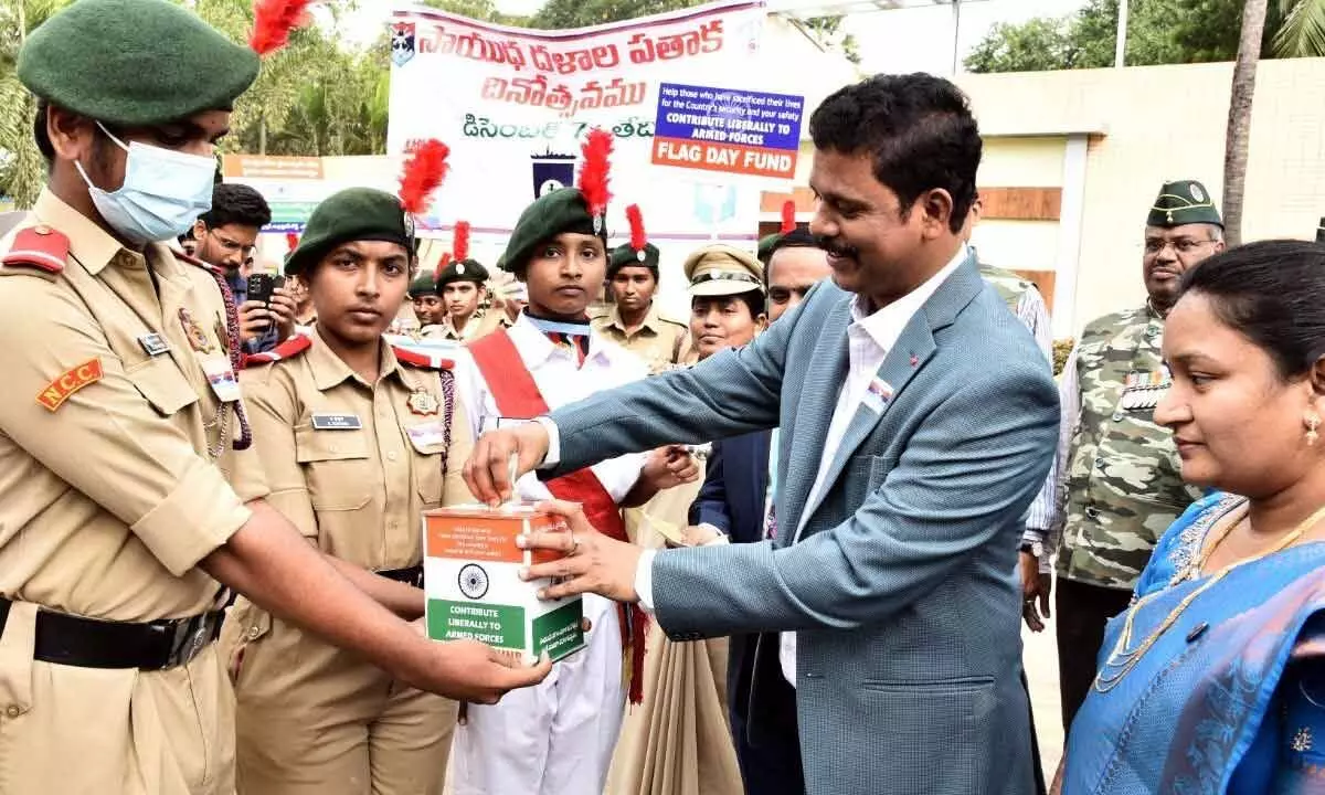 NTR district collector S Dilli Rao donating for the Flag Day in Vijayawada on Wednesday. Surgeon Lieutenant Commander Kalyana Veena also seen.