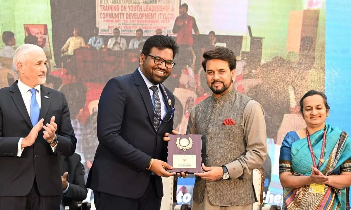 Union Minister of Cultural and Youth Affairs Anuragh Singh Thakur presents UNV award to Bisathi Bharath at New Delhi.