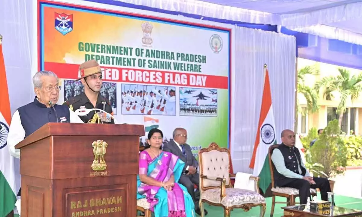 Governor Biswabhusan Harichandan addressing a programme organised as part of Armed Forces Flag Day celebrations at Raj Bhavan in Vijayawada on Friday. Home minister T Vanitha and others are also seen.