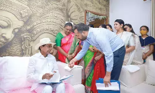 District collector RV Karnan presenting the booklet containing success stories of Dalit Bandhu beneficiaries to Chief Minister K Chandrshekhar Rao in Karimnagar, on Thursday