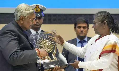 President Droupadi Murmu receives a memento from NHRC Chairman Justice Arun Kumar Mishra during the celebrations of Human Rights Day, at Vigyan Bhavan in New Delhi on Saturday