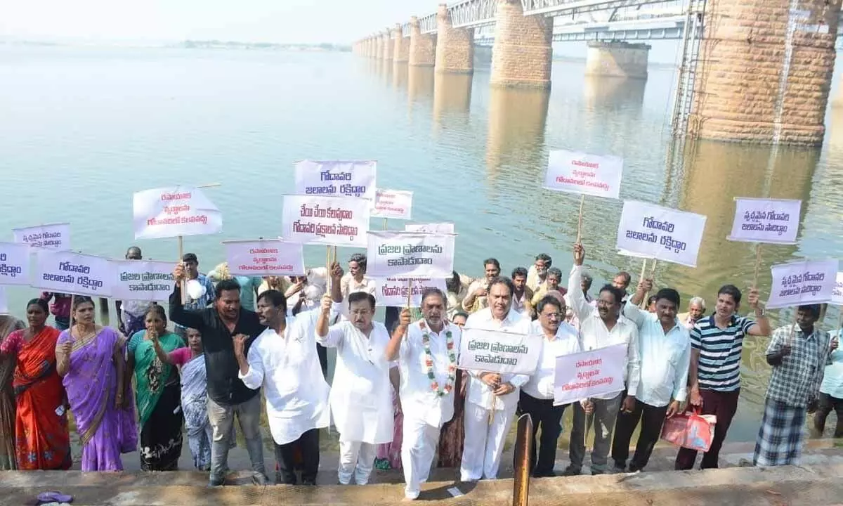 Godavari Conservation Committee president TK Visweswara Reddy, ONGC retired ED DMR Sekhar and others staging a protest at Pushkar Ghat in Rajamahendravaram on Wednesday