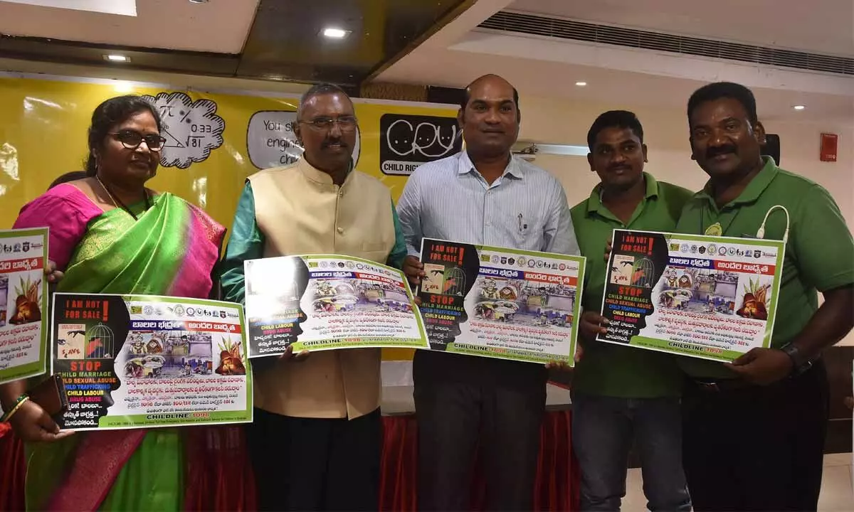 Press Academy Chairman Kommineni Srinivasa Rao and CRY members unveiling posters at a programme in Vijayawada on Wednesday