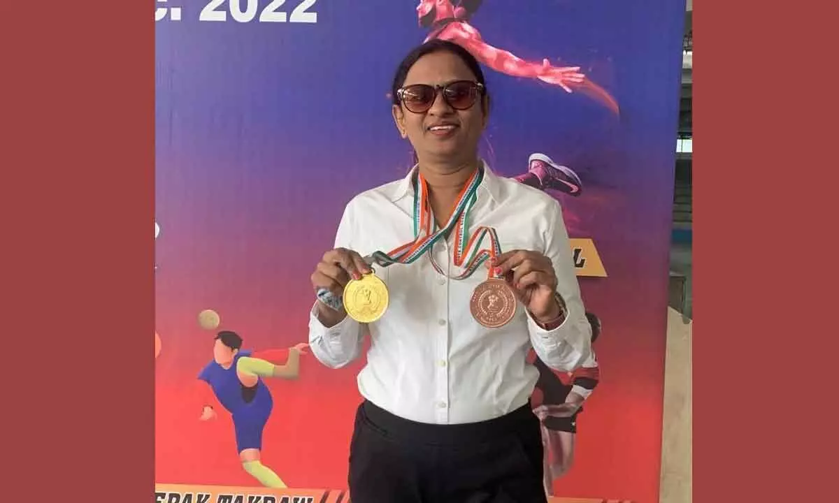 Intelligence Inspector Tenka Kalyani displaying her medals won in yoga in the 71st All India Police Volleyball Cluster- 2022 Tournament
