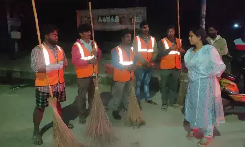 Mayor Dr R Sirisha interacting with sanitary workers near bus stand area in Tirupati on Friday
