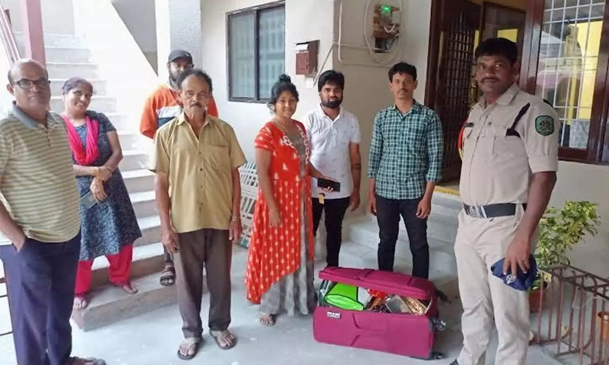 Police handing over the lost luggage of a woman in Visakhapatnam on Sunday