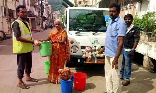 Municipal staff collecting garbage from households