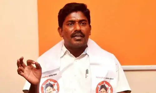 JSP corporator Peethala Murthy Yadav addressing the media in Visakhapatnam on Tuesday