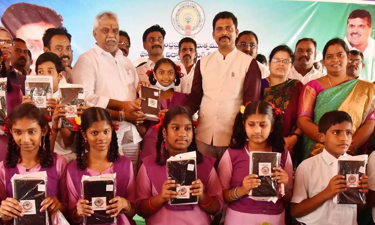 Central MLA Malladi Vishnu and Collector Dilli Rao distributing tabs to students in Vijayawada on Wednesday