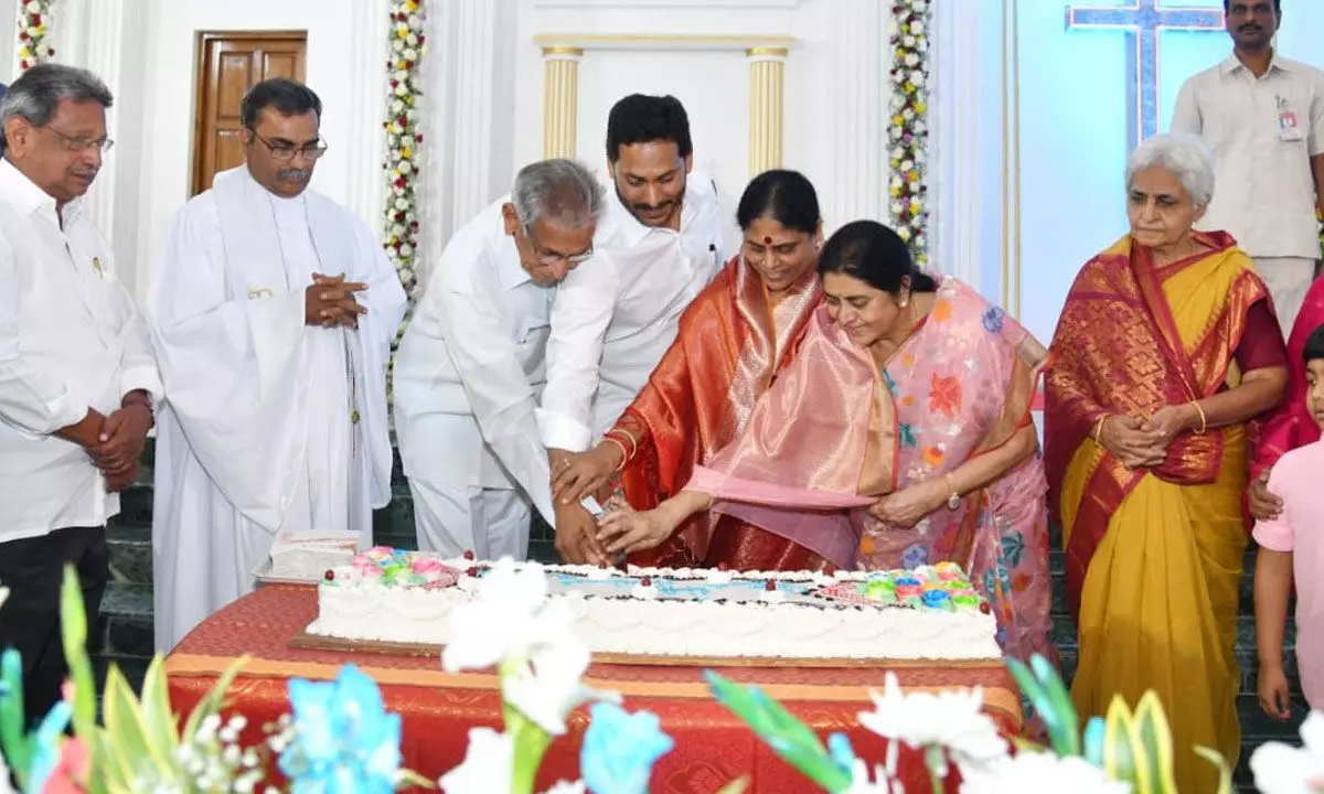 Chief Minister Y S Jagan Mohan Reddy, his mother Y S Vijayamma and others cutting a cake as part of the Christmas celebrations at the CSI Church in Pulivendula on Sunday