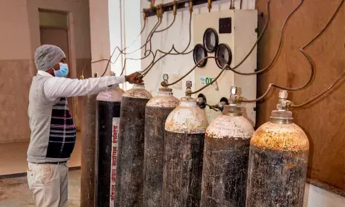 A health worker checks oxygen cylinders as part of preparedness against Covid-19, at Government District Hospital in Mirzapur on Monday