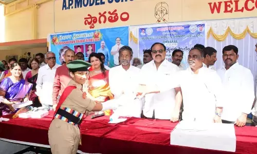 Panyam MLA Katasani Rambhupal Reddy distributing tabs to the students at Orvakal Model High School on Tuesday