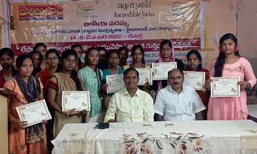 Historian MyNaa Swamy and Balaji College Principal Dr A Veerabhadrappa distributing certificates to students at a programme in Anantapur on Friday