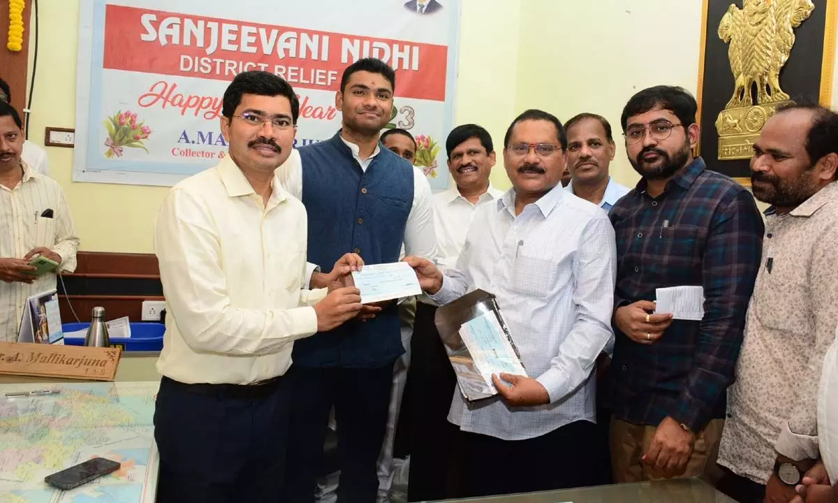 District Collector Mallikarjuna handing over a cheque for Sanjeevani Nidhi District Relief Fund in Visakhapatnam on Sunday