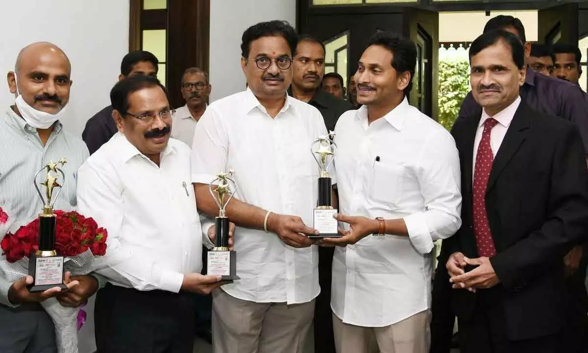 Special Chief Secretary (Energy) K Vijayanand, AP Transco CMD B Sreedhar and other officials showing the national awards won by the Energy Department to Chief Minister Y S Jagan Mohan Reddy at his camp office in Tadepalli on Monday. Chief Secretary K S Jawahar Reddy is also seen.